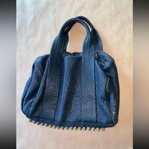 Alexander wang bag 4 studs missing at the bottom.